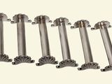 six stainless steel rods are lined up on a white surface