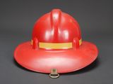 a red fireman ' s hat on a black background