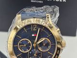 a close up of a person holding a watch in front of a box