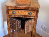 a small wooden table with a basket on top of it