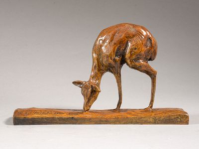 sculpture of a deer on a wooden base on a white background