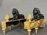 pair of bronze lions on a bench with a bird on it
