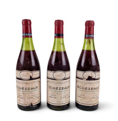 three bottles of wine sitting next to each other on a white surface