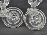 pair of crystal wine glasses on a black background with a black background
