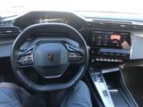 the interior of a car with a steering wheel, dashboard, and display screen