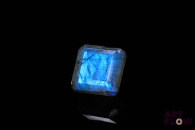 an image of a square shaped blue stone on a black surface