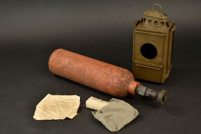 an old fashioned bottle with a paper towel next to it