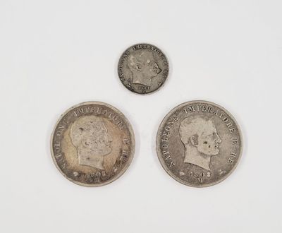 three coins of different sizes and shapes on a white surface