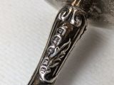 a silver spoon with a handle on a table