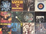 many different album covers on the wall of a room