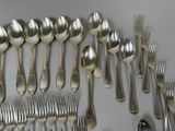 a lot of silver spoons and forks on the table
