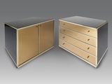 two black and gold dressers with brass handles and drawers