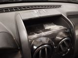 a dirty dashboard of a car with a bunch of items in it