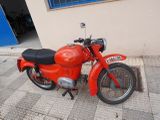 a red motorcycle parked on the side of the street