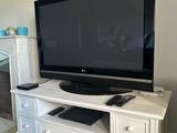 a tv that is sitting on top of a dresser