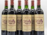 six bouteilles de vin rouge sont alignées