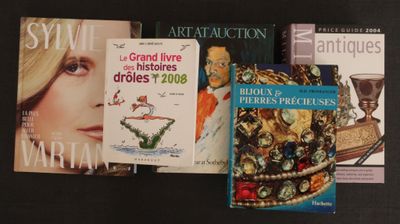 several books on a black table with a gold crown on top of them
