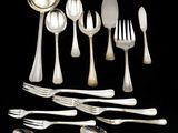 an assortment of silverware including spoons, forks and spoons