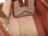 a brown purse with a zipper on the inside of it