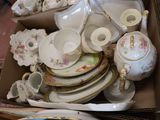 a box full of china plates and cups and saucers