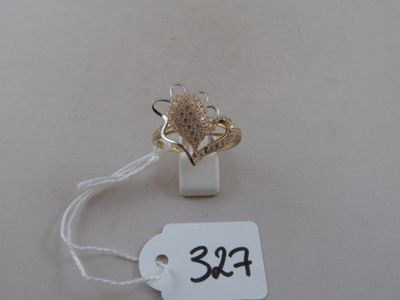 a gold ring with a flower on it and a price tag