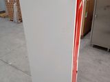 a white refrigerator with a red door in a room