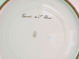 a plate with writing on it sitting on a table