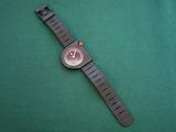 a watch that is laying on a green surface