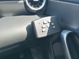 a car dashboard with a steering wheel and an air vent