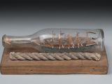 a ship in a bottle with a rope on a board