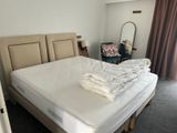a bed with a white sheet on it in a room
