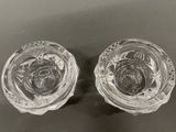 pair of clear glass salt and pepper shakers on a table