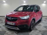the red opel is parked in a large room with a checkered floor