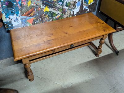 a small wooden table with a drawer underneath it