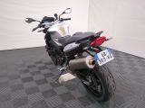 a motorcycle that is parked in a room with a checkered floor