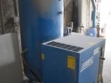 a large blue tank sitting next to a blue machine