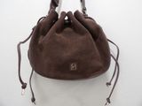 brown sued purse on white background with brown leather handles