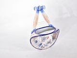 blue and white ceramic hanging planter with a blue ribbon