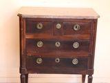 a wooden chest of drawers with brass knobs on it