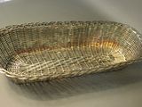 a wicker basket sitting on a table in a room