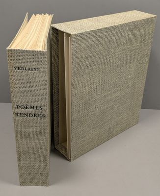 an open book sitting on top of a table next to a gray wall