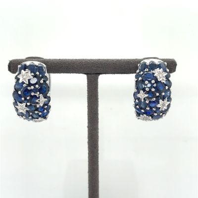 pair of blue sapphire and diamond earrings on display on a stand