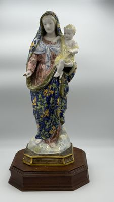 an image of a statue of a woman holding a child