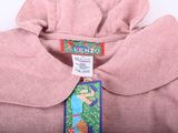 a pink shirt with a blue tag on it