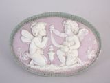 a picture of a pink and white plaque with angels on it