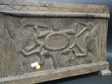 an image of a wooden box with carvings on it on a black background