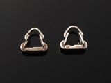 a pair of silver earrings on a black surface
