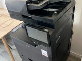 a black printer sitting on top of a stack of boxes