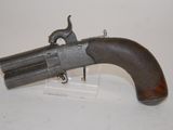 an old gun that is on display on a white surface