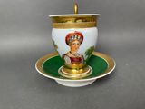 a cup and saucer with a picture of a woman on it